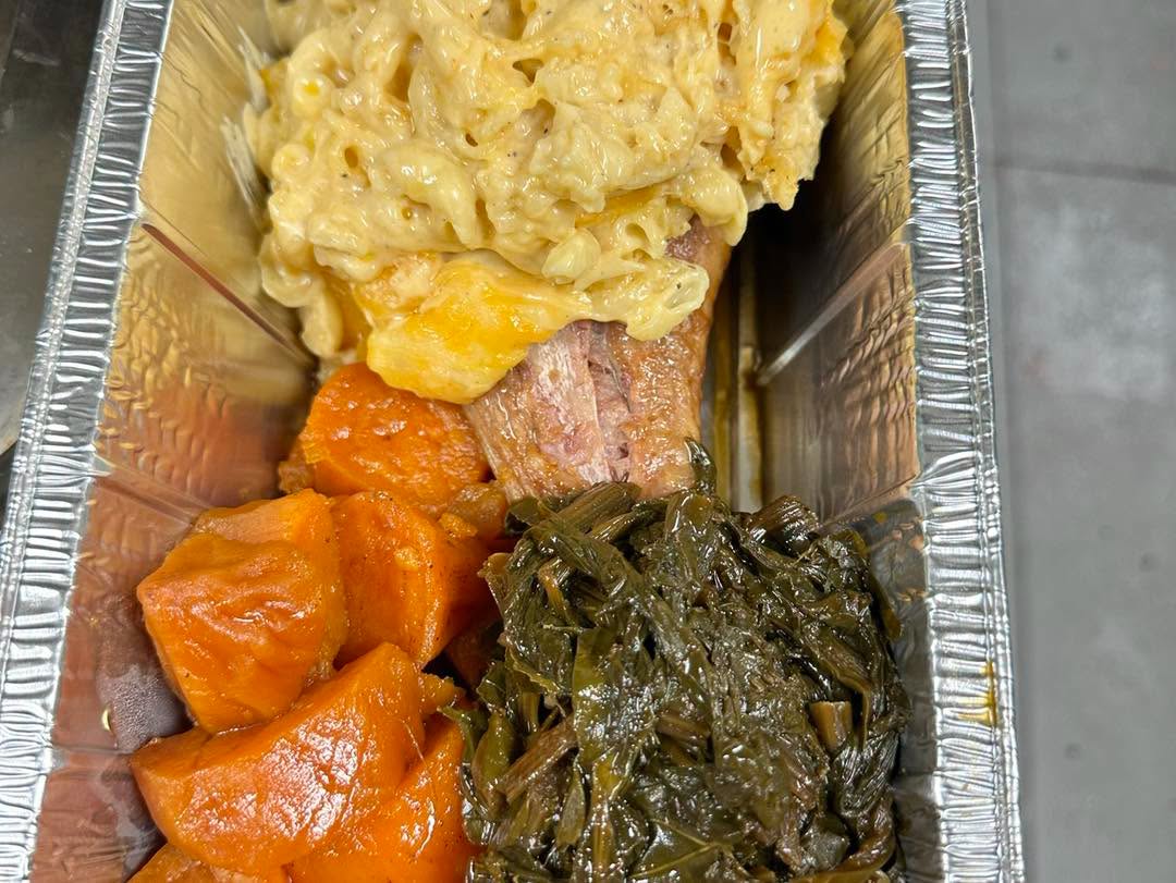 Ray's Soul Food Turkey Leg packed to-go with mac and cheese, candied yams, and greens